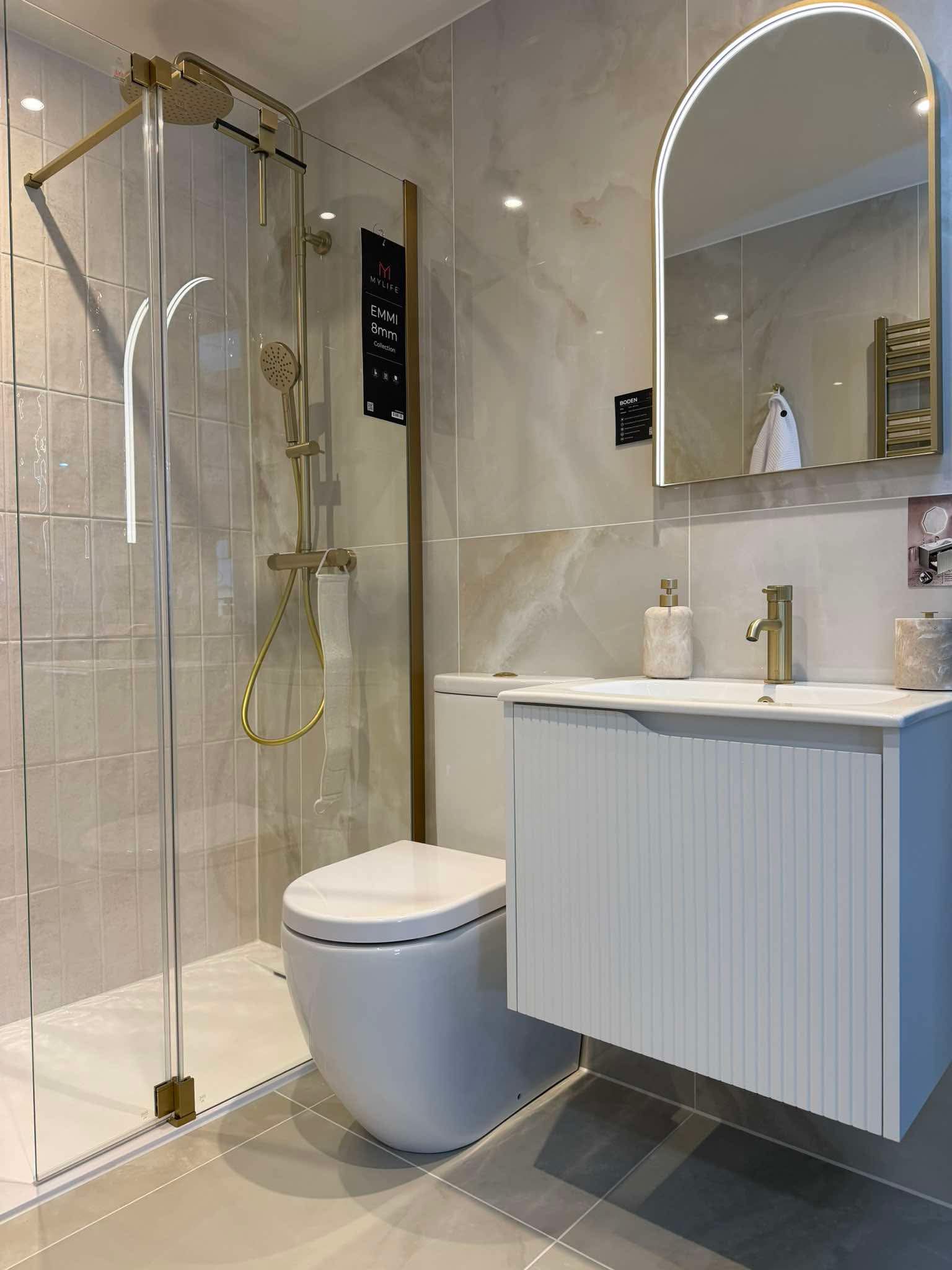 Brushed gold walk-in shower enclosure and vanity on display in the BDR Bathroom Innovation showroom, Kirkcaldy
